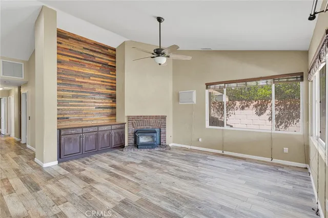 wooden floor in an empty room with a fireplace