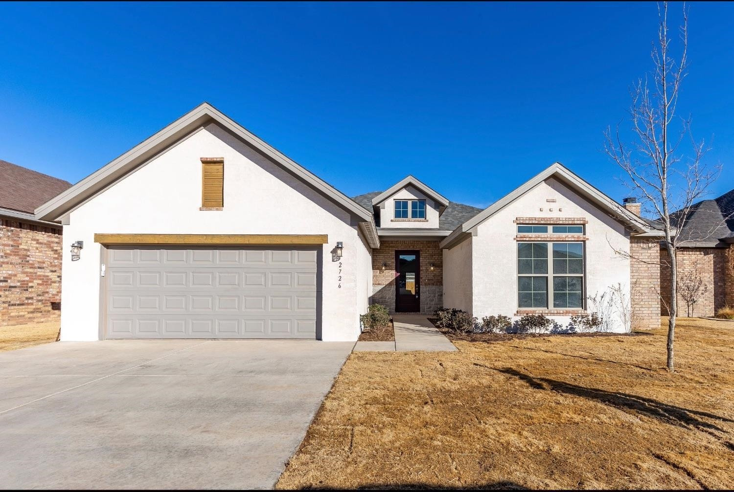 2726 138th Street Lubbock, TX 79423 - Photo 1 of 18 a front view of a house with a yard and garage