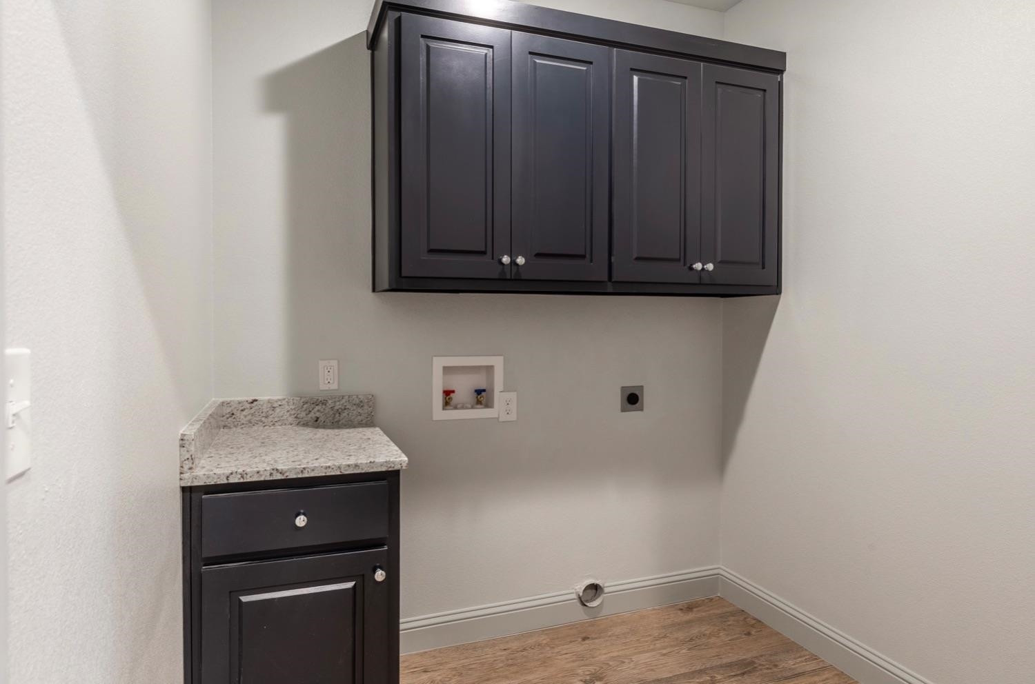2726 138th Street Lubbock, TX 79423 - Photo 17 of 18 a view of a storage and utility room with wooden floor