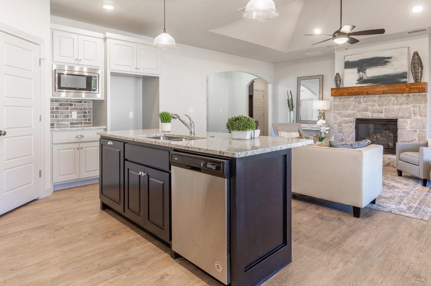 2726 138th Street Lubbock, TX 79423 - Photo 3 of 18 a kitchen with kitchen island granite countertop a sink cabinets and window