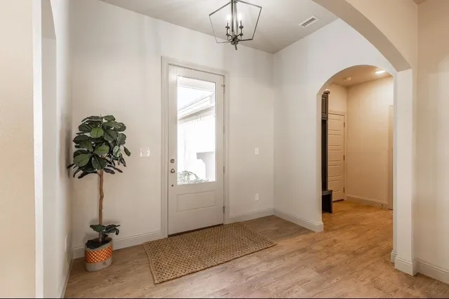 a view of kitchen with kitchen island stainless steel appliances living room living room and windows