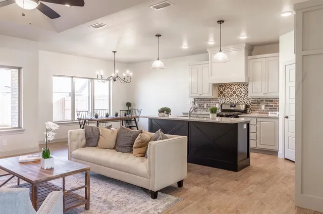 a kitchen with granite countertop a stove sink and cabinets