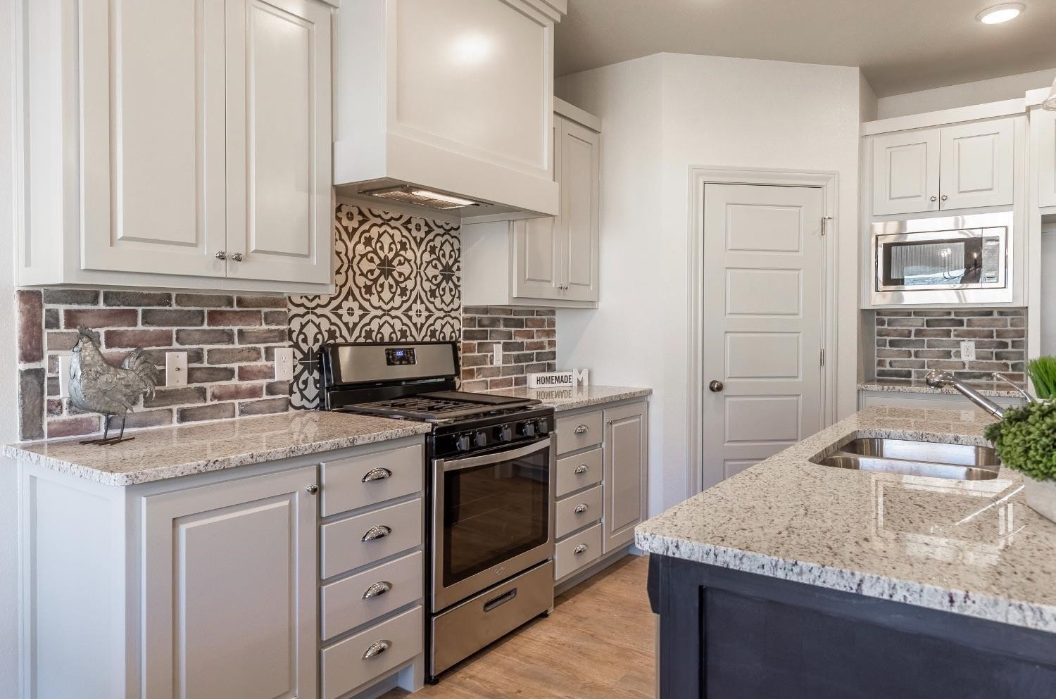 2726 138th Street Lubbock, TX 79423 - Photo 6 of 18 a kitchen with granite countertop a stove sink and cabinets