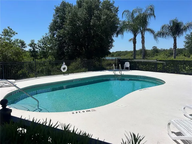 a view of a swimming pool with a patio