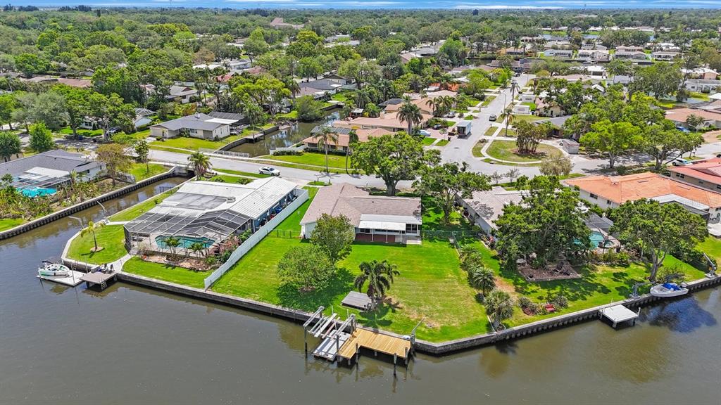 an aerial view of a pool with a yard