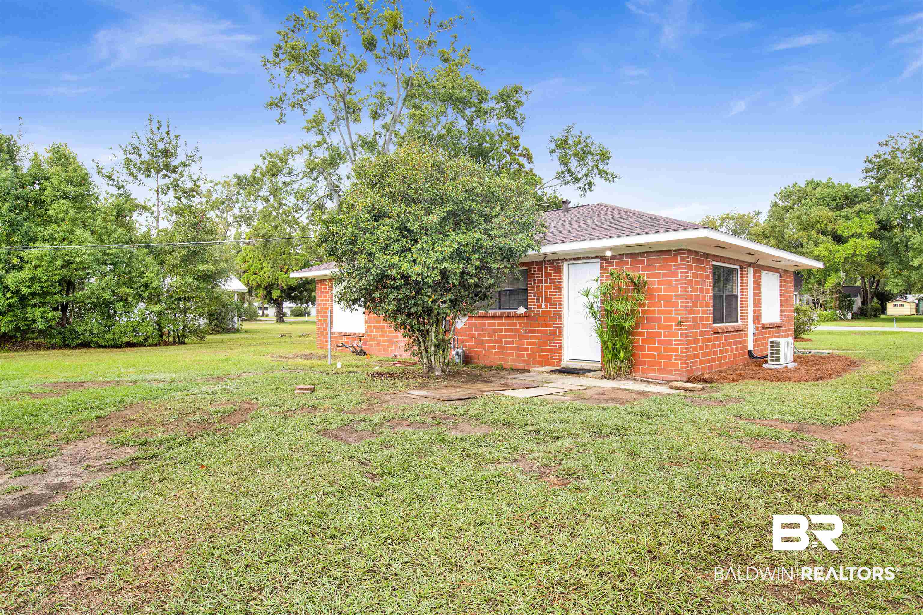 311 West Myrtle Avenue Foley, AL 36535 - Photo 18 of 22 View of side of home featuring cooling unit and a yard