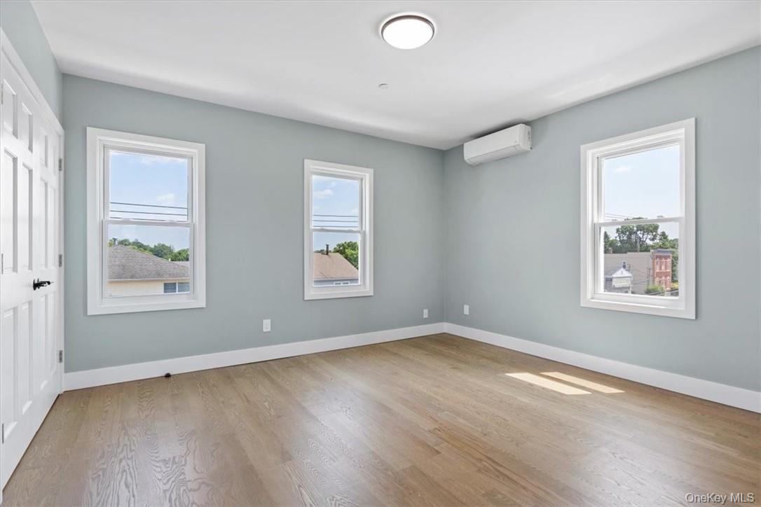 76 Crotona Avenue, Unit 3 Harrison, NY 10528 - Photo 9 of 9 a view of an empty room with wooden floor and a window