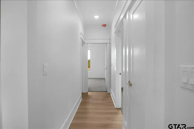 a view of a hallway with wooden floor