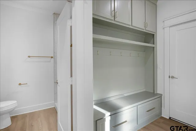 a bathroom with a sink a toilet and a mirror