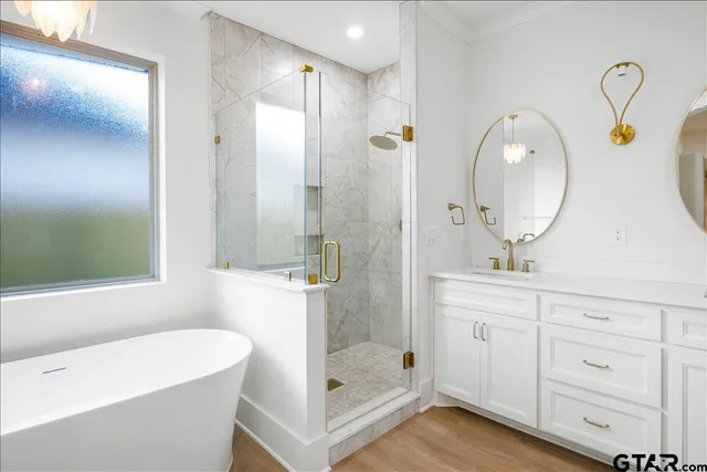 a bathroom with a tub sink and mirror