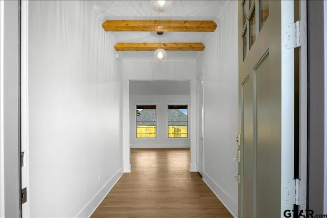 a view of an entryway with wooden floor