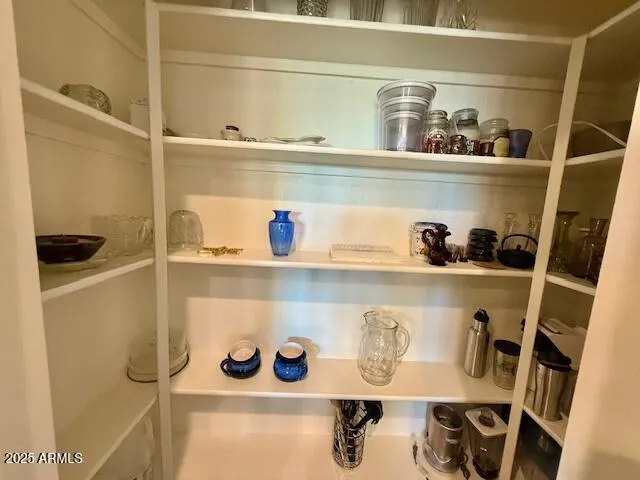 a spacious bedroom with a balcony a bed and a large window with wooden floor