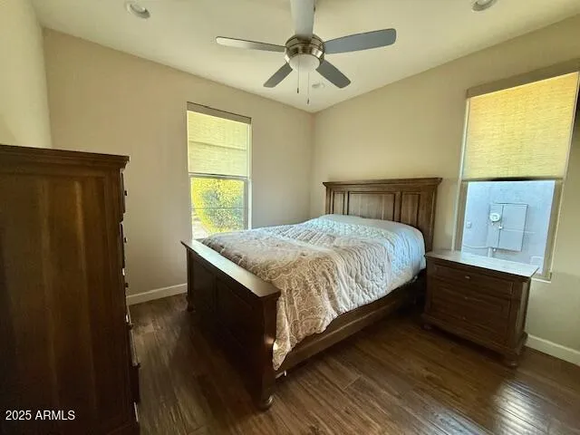 a bed sitting in a bedroom next to a window
