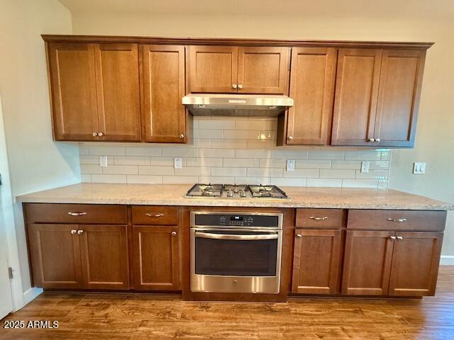 17259 East Woolsey Way Rio Verde, AZ 85263 - Photo 9 of 28 a kitchen with granite countertop a stove a sink and a cabinets
