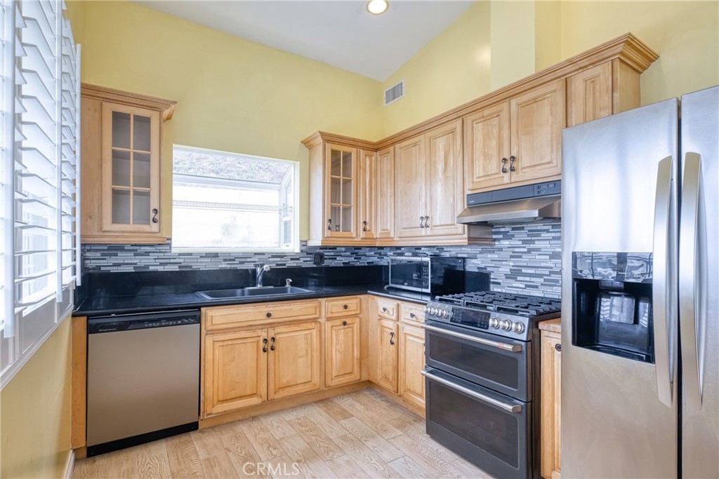 591 Devonwood Road Altadena, CA 91001 - Photo 24 of 51 a kitchen with granite countertop a sink stainless steel appliances and cabinets