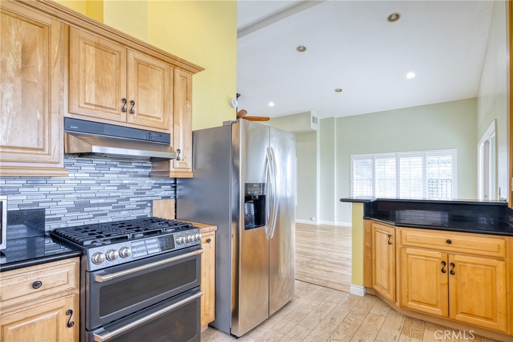591 Devonwood Road Altadena, CA 91001 - Photo 25 of 51 a kitchen with stainless steel appliances granite countertop a stove and a refrigerator