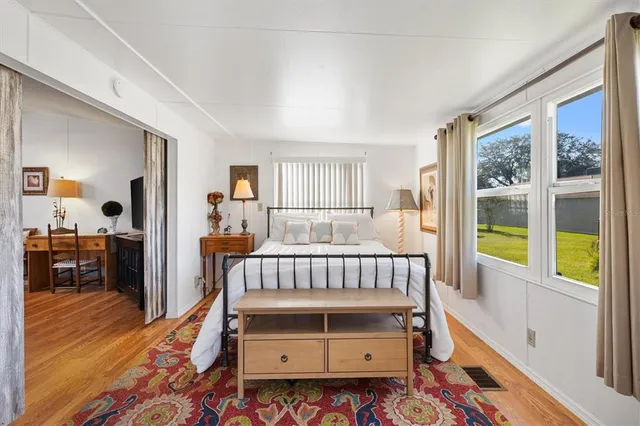 a bedroom with furniture and a window