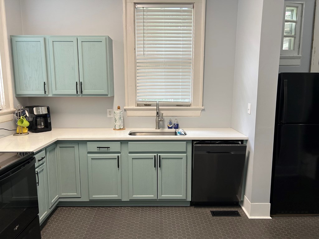 1192 Munro Avenue Columbus, GA 31906 - Photo 5 of 10 a kitchen with a sink cabinets and a refrigerator