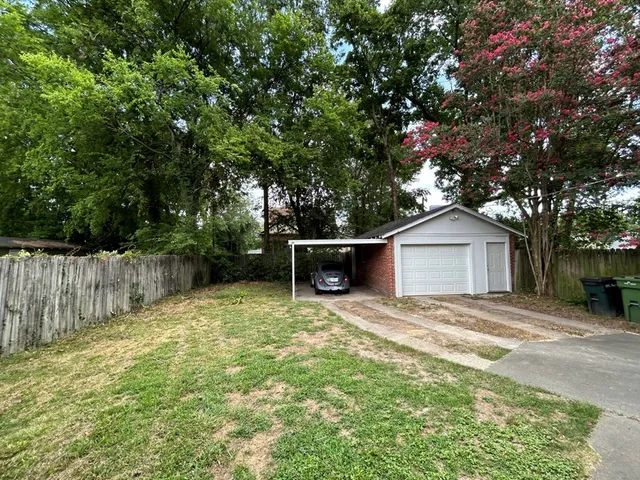 a backyard of a house with large trees