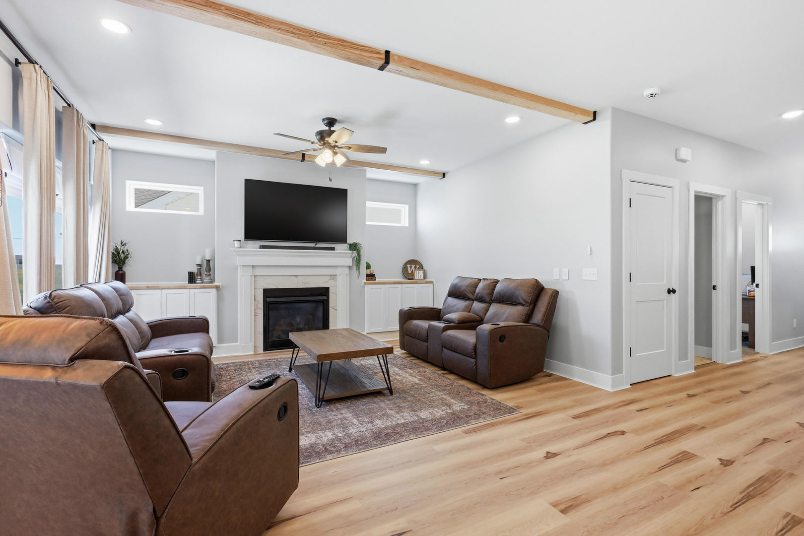 6779 Genesis Way Bettendorf, IA 52722 - Photo 15 of 36 a living room with furniture a flat screen tv and a fireplace