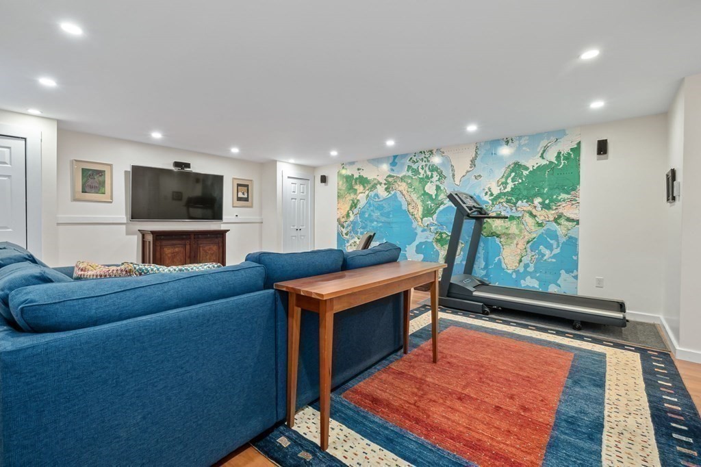 11 Boxford Road Topsfield, MA 01983 - Photo 32 of 34 a living room with furniture a flat screen tv and a fireplace