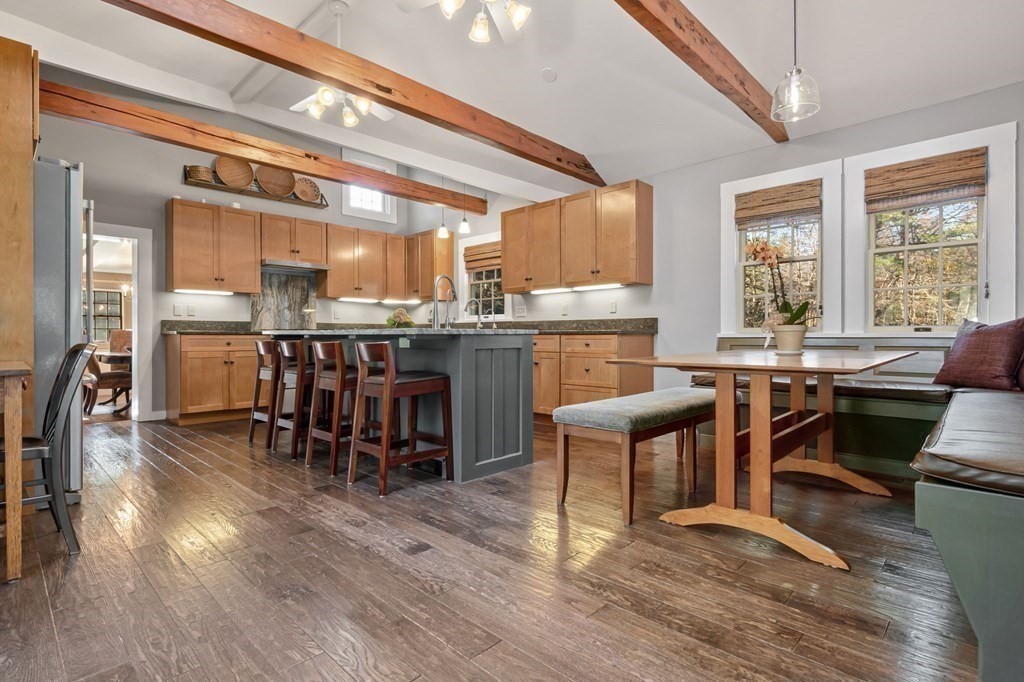 11 Boxford Road Topsfield, MA 01983 - Photo 8 of 34 a dining hall with stainless steel appliances kitchen island granite countertop a dining table chairs and view of living room
