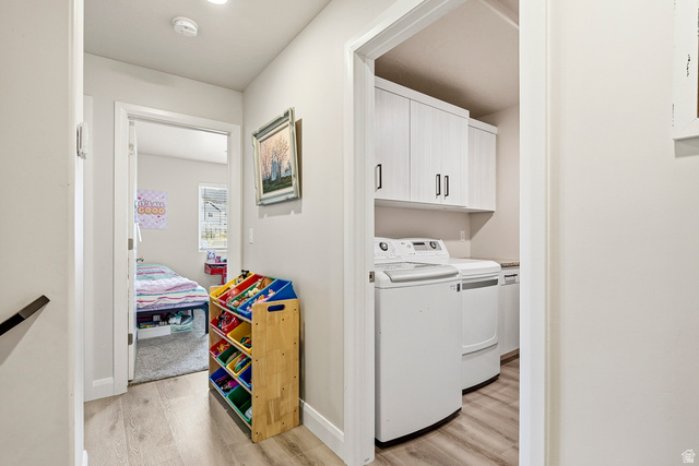 668 East Fiddlers Canyon Road, Unit 6 Cedar City, UT 84721 - Photo 26 of 36 Dedicated laundry area featuring white cabinetry with dark hardware and wood-finish flooring