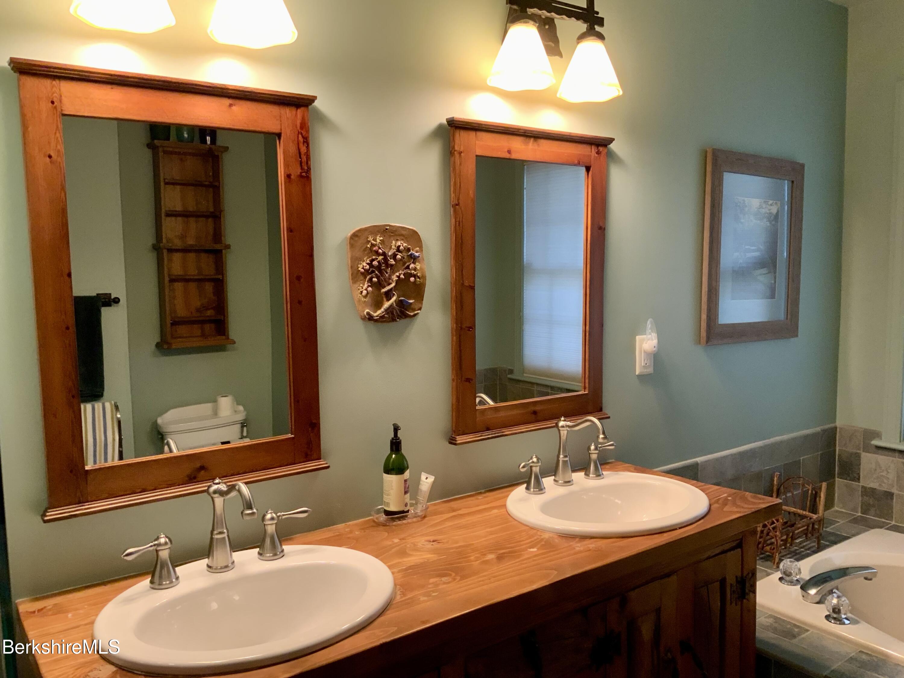 1136 Barker Road, Unit 66 Pittsfield, MA 01201 - Photo 21 of 33 a bathroom with a sink and a mirror