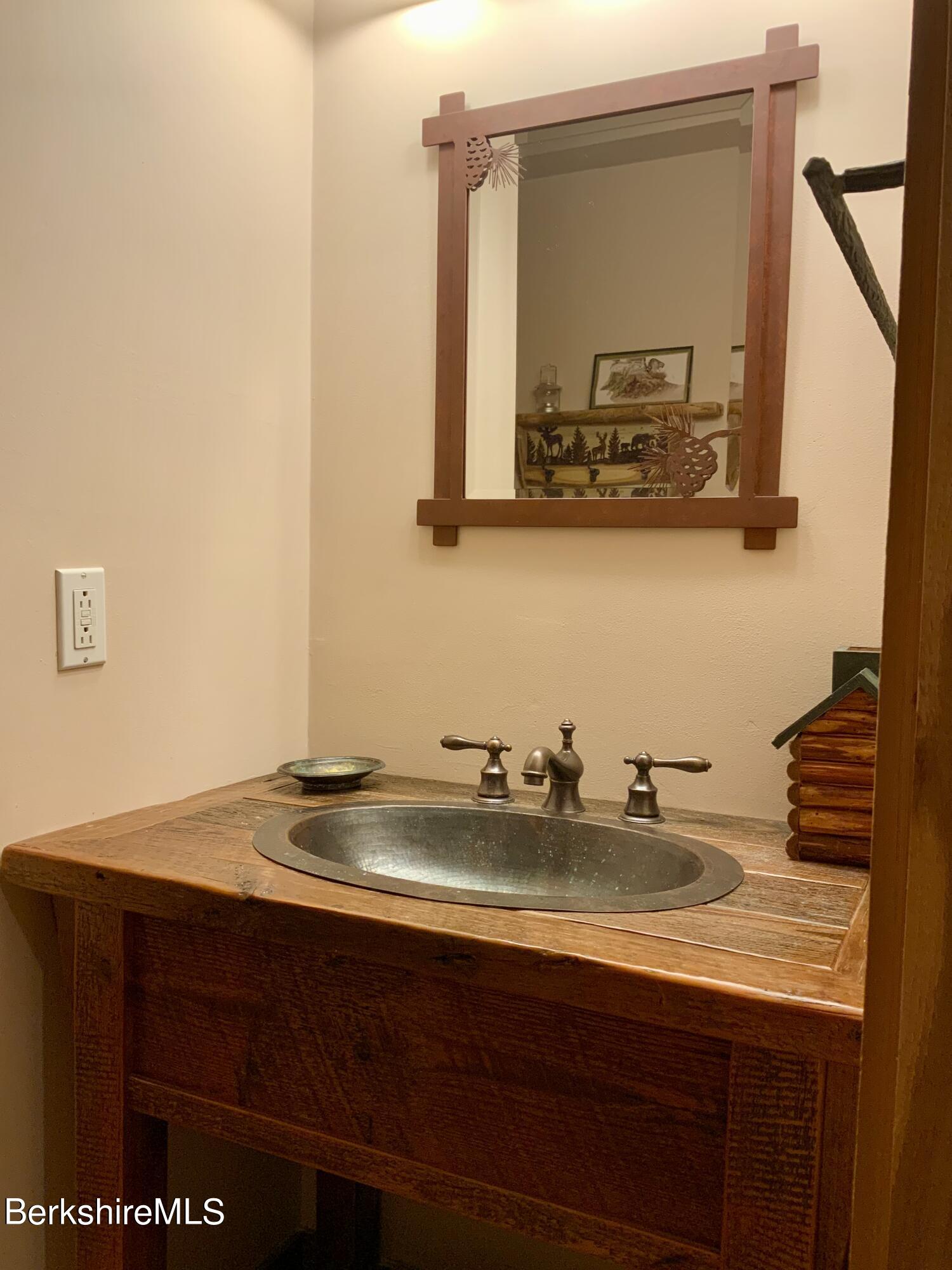 1136 Barker Road, Unit 66 Pittsfield, MA 01201 - Photo 27 of 33 a bathroom with a sink and a mirror