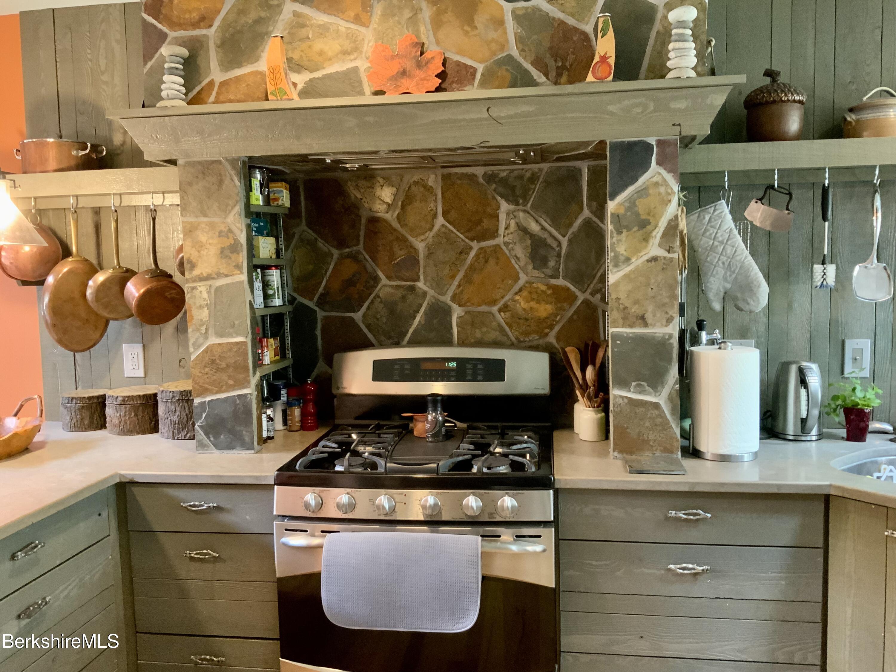1136 Barker Road, Unit 66 Pittsfield, MA 01201 - Photo 8 of 33 a stove top oven sitting inside of a kitchen