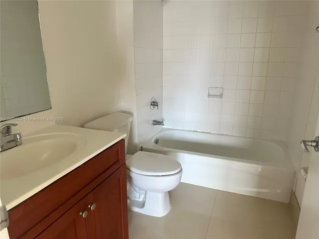 a bathroom with a granite countertop toilet a sink and bathtub