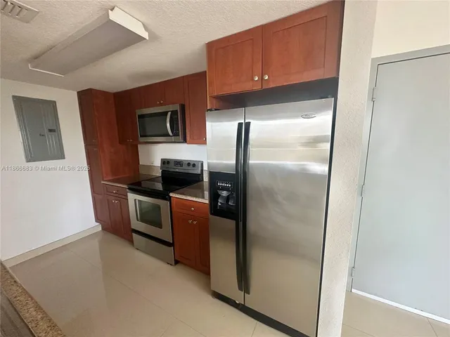 a kitchen with stainless steel appliances a refrigerator and a stove