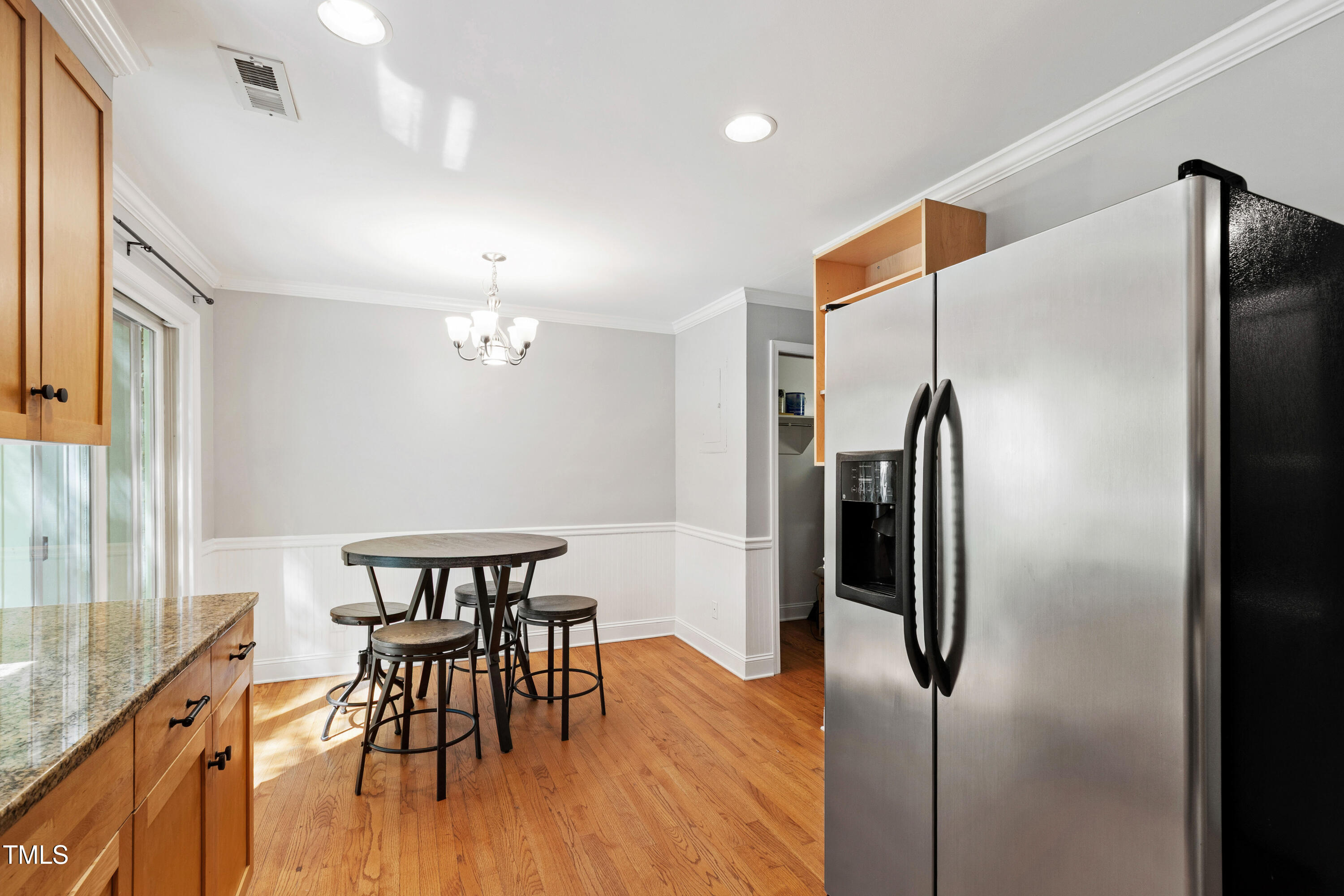 409 Smith Avenue, Unit 102 Chapel Hill, NC 27516 - Photo 12 of 35 a kitchen with stainless steel appliances refrigerator dining table and chairs
