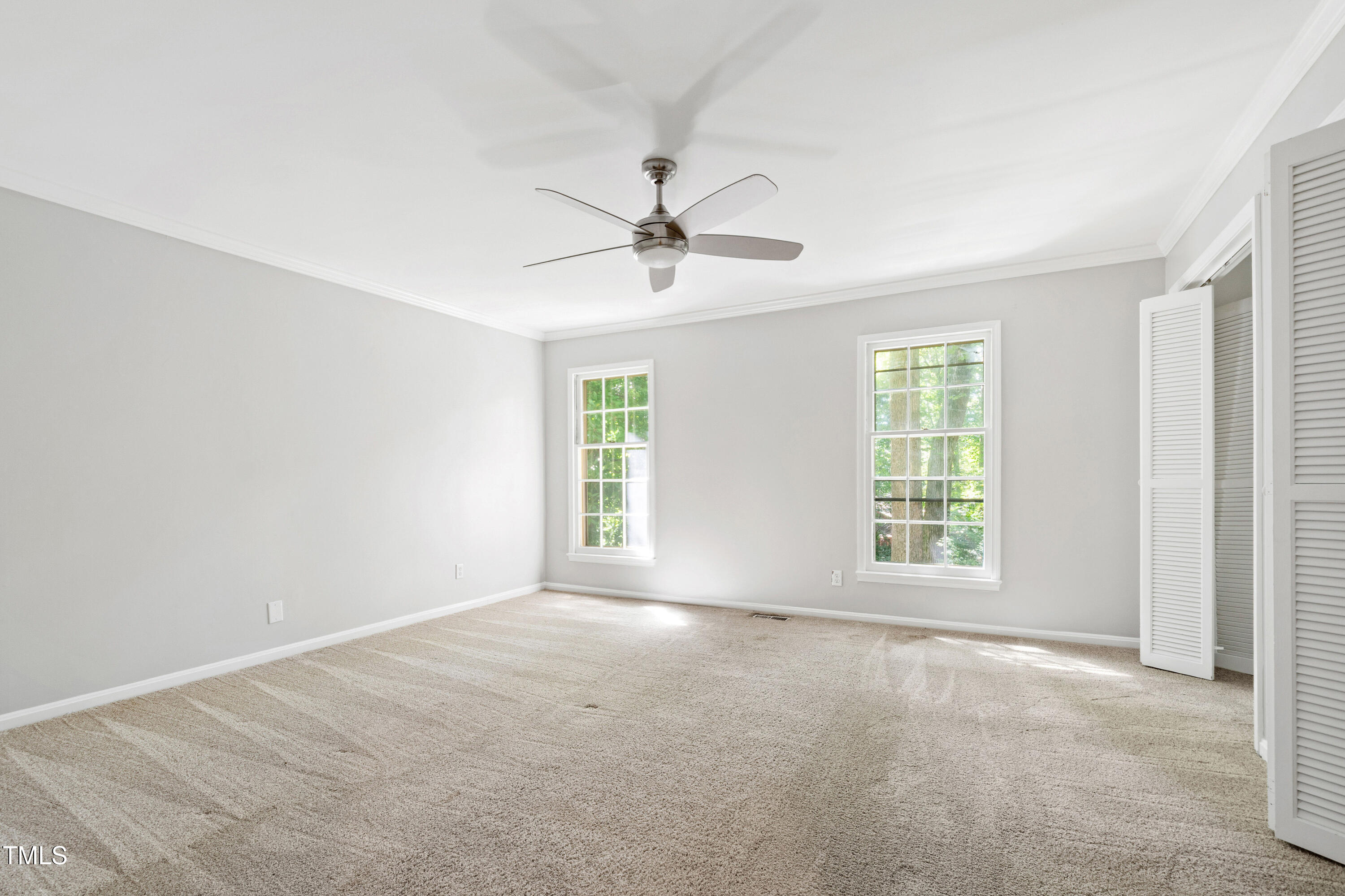 409 Smith Avenue, Unit 102 Chapel Hill, NC 27516 - Photo 16 of 35 an empty room with windows and a ceiling fan