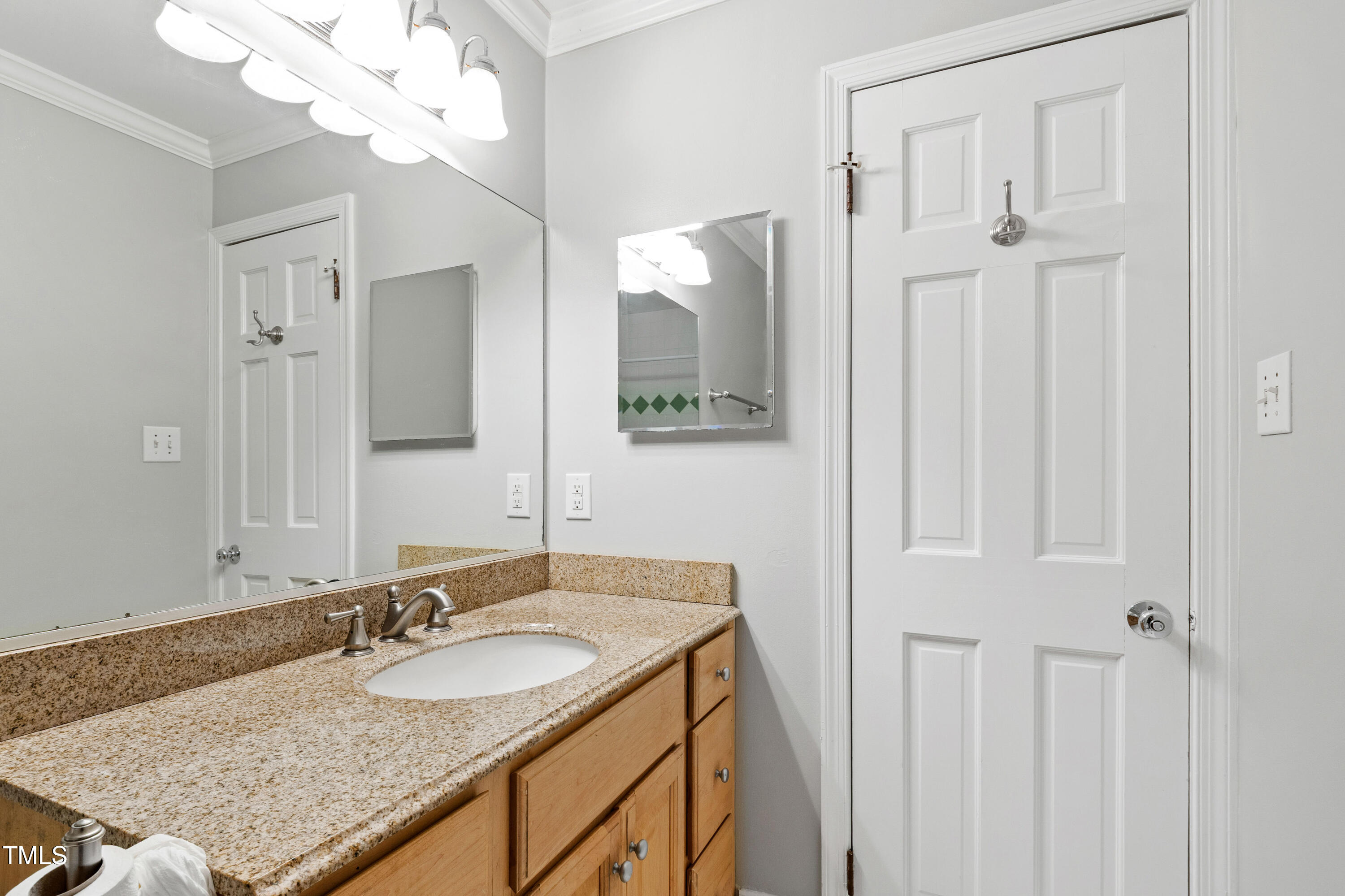 409 Smith Avenue, Unit 102 Chapel Hill, NC 27516 - Photo 19 of 35 a bathroom with a granite countertop sink and a mirror
