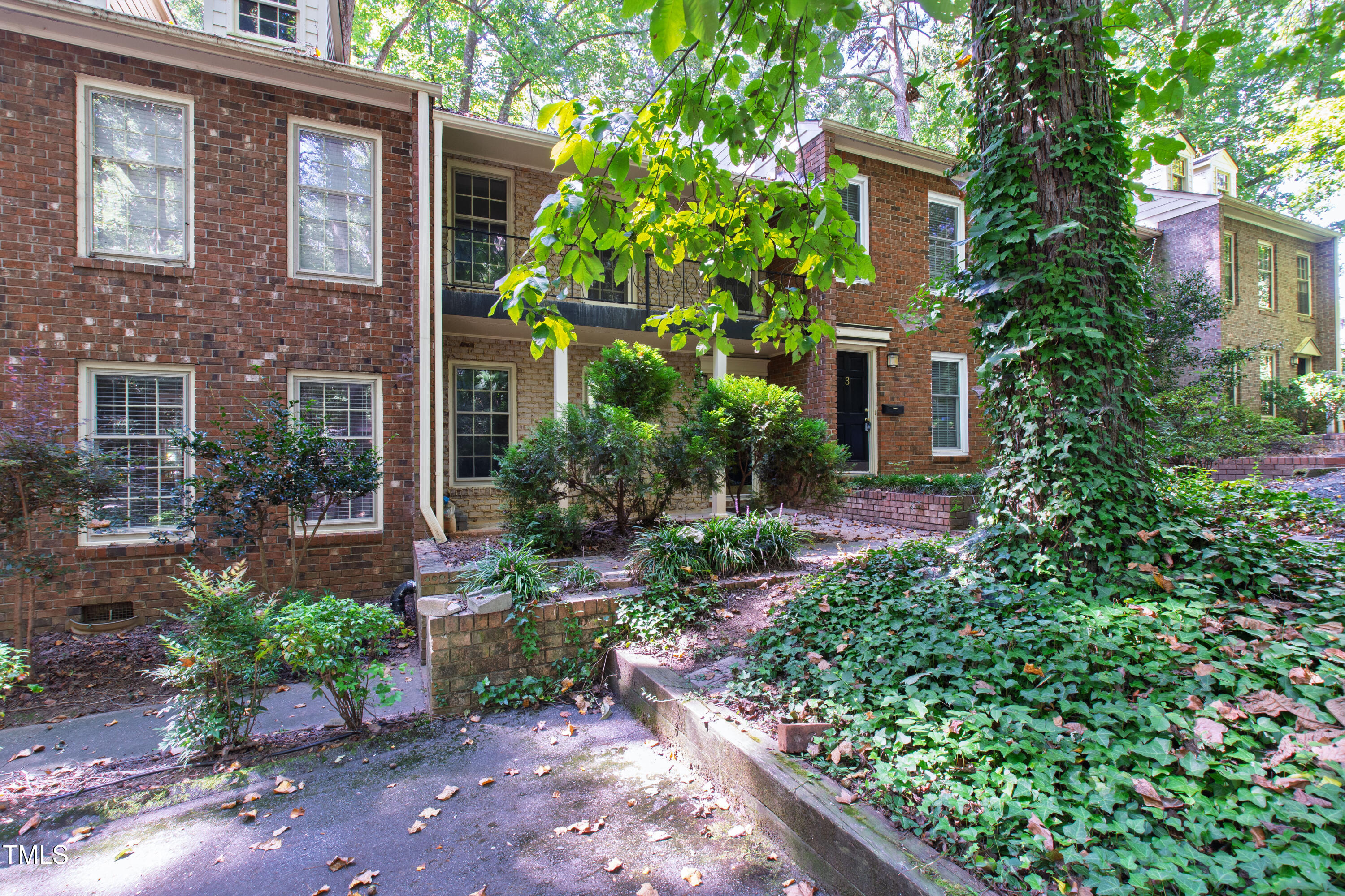 409 Smith Avenue, Unit 102 Chapel Hill, NC 27516 - Photo 33 of 35 a view of a brick house with a yard and plants