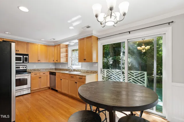 a kitchen with stainless steel appliances granite countertop a stove a sink and a refrigerator