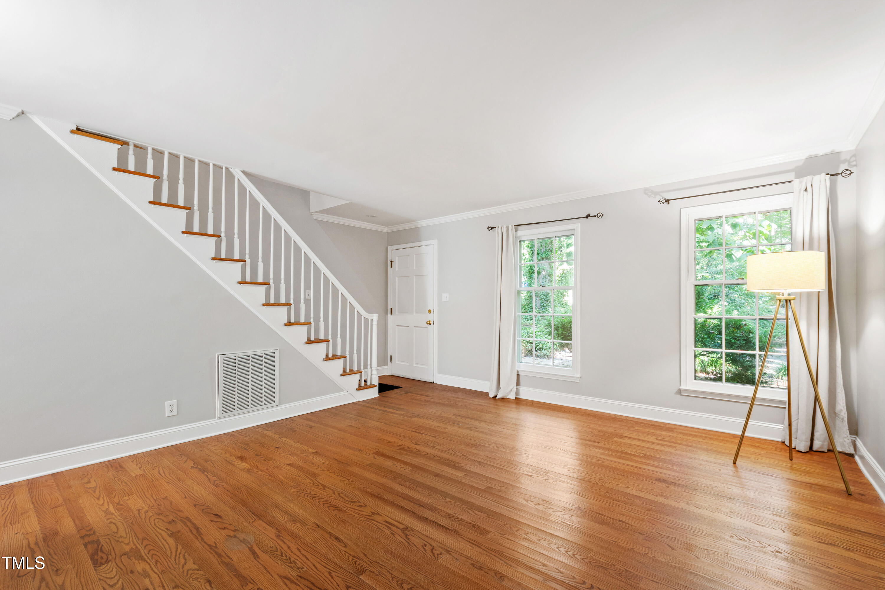 409 Smith Avenue, Unit 102 Chapel Hill, NC 27516 - Photo 3 of 35 a view of an empty room with wooden floor and a window