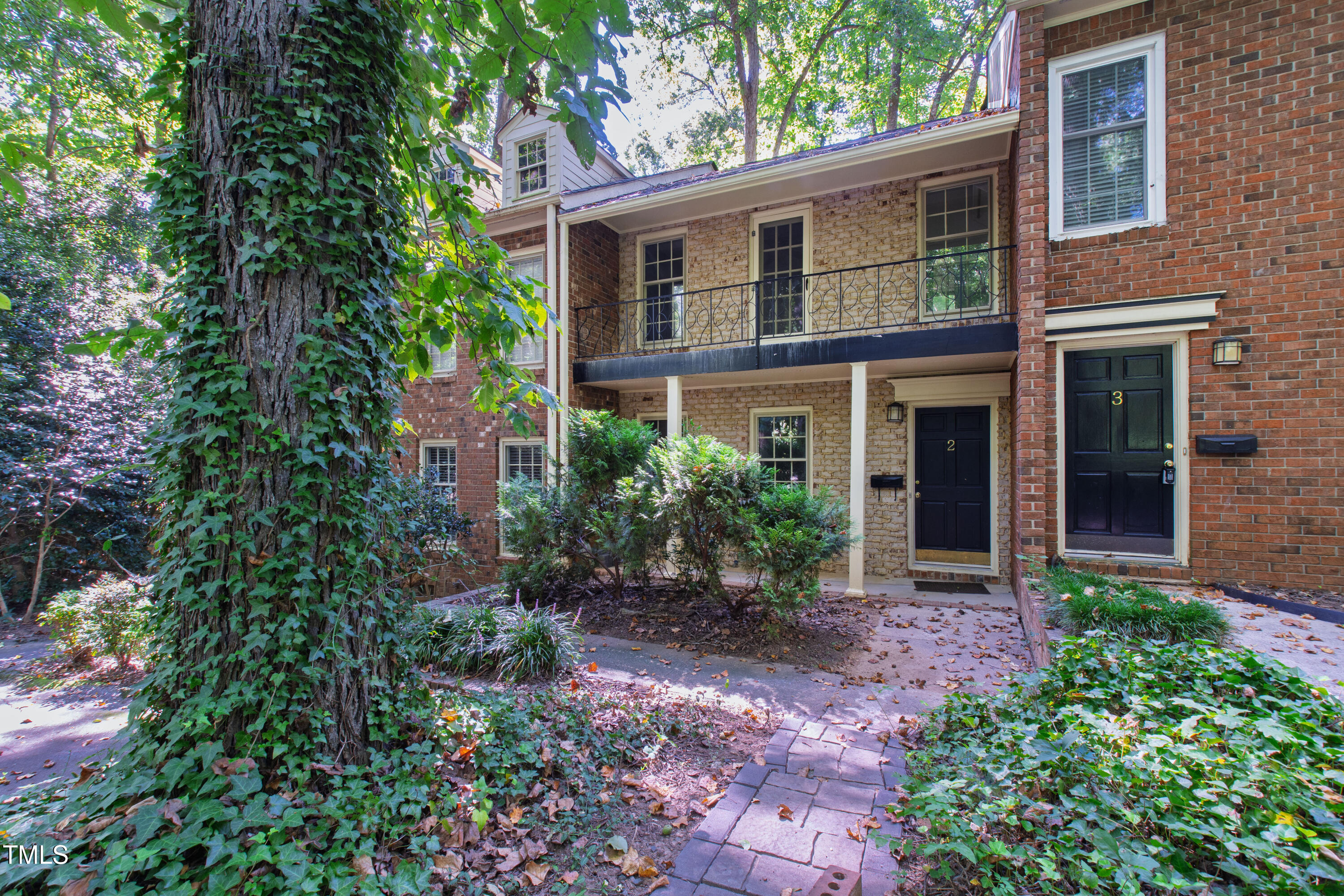 409 Smith Avenue, Unit 102 Chapel Hill, NC 27516 - Photo 5 of 35 a view of a brick house with a yard and potted plants