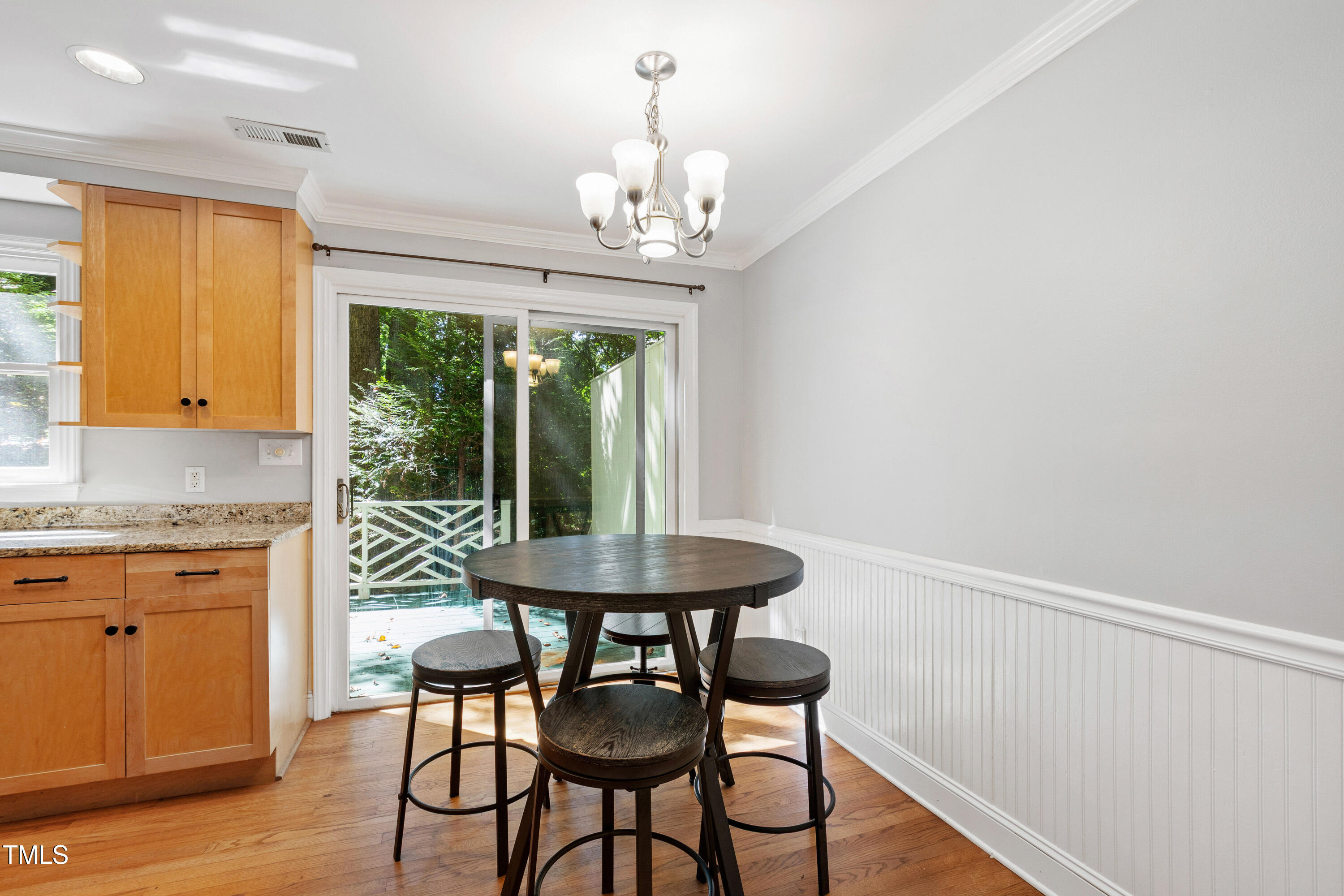 409 Smith Avenue, Unit 102 Chapel Hill, NC 27516 - Photo 9 of 35 a dining room with furniture a chandelier and wooden floor