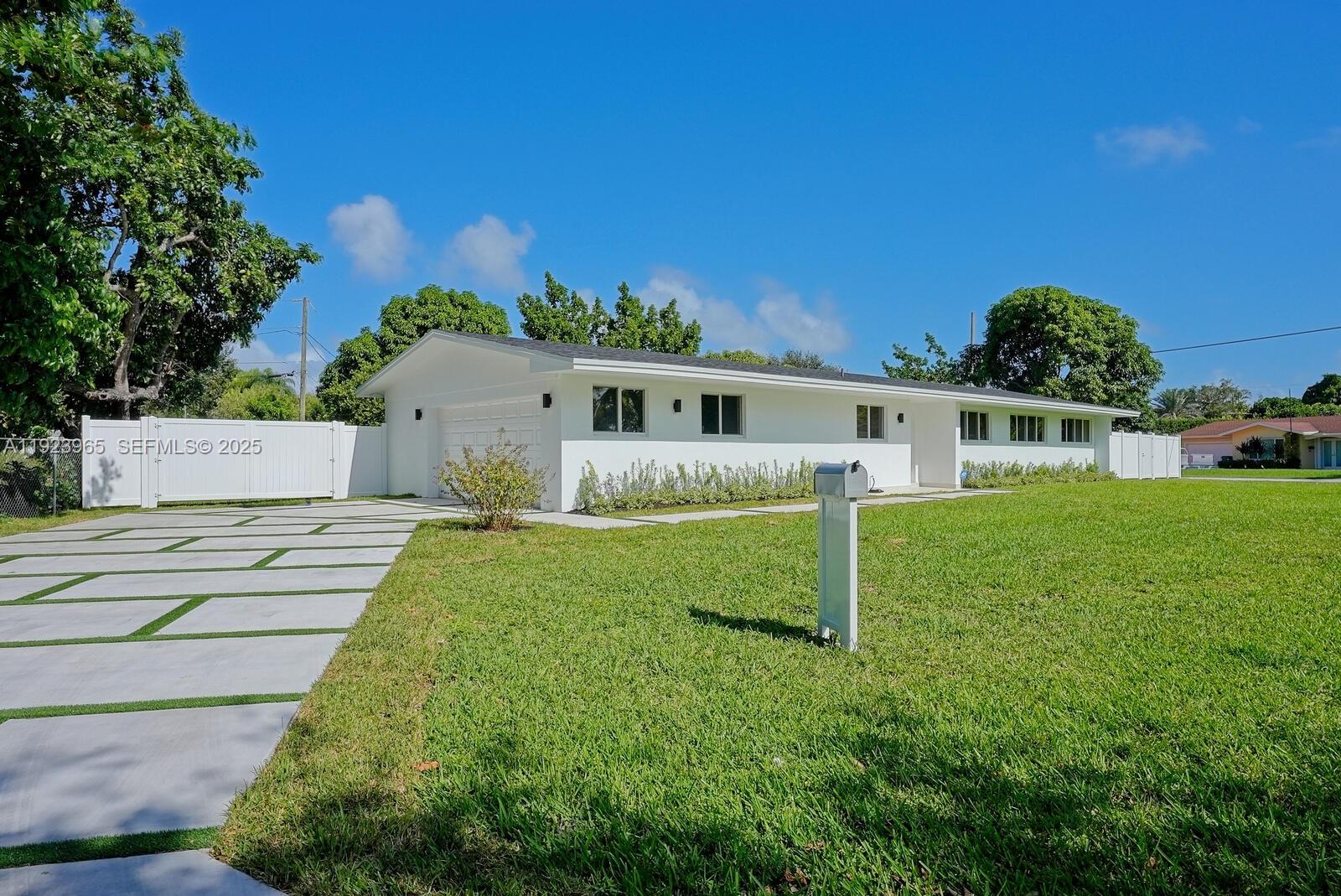 9301 Southwest 178th Street Palmetto Bay, FL 33157 - Photo 1 of 23 a house view with a garden space