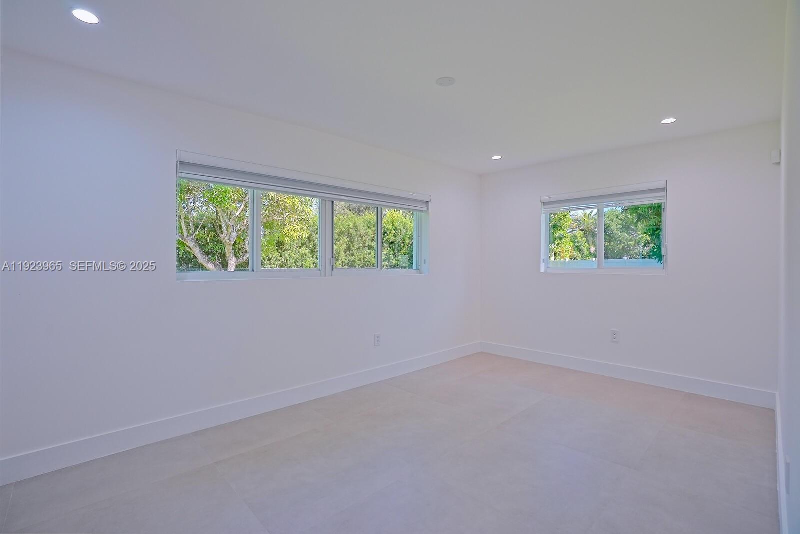 9301 Southwest 178th Street Palmetto Bay, FL 33157 - Photo 11 of 23 an empty room with windows