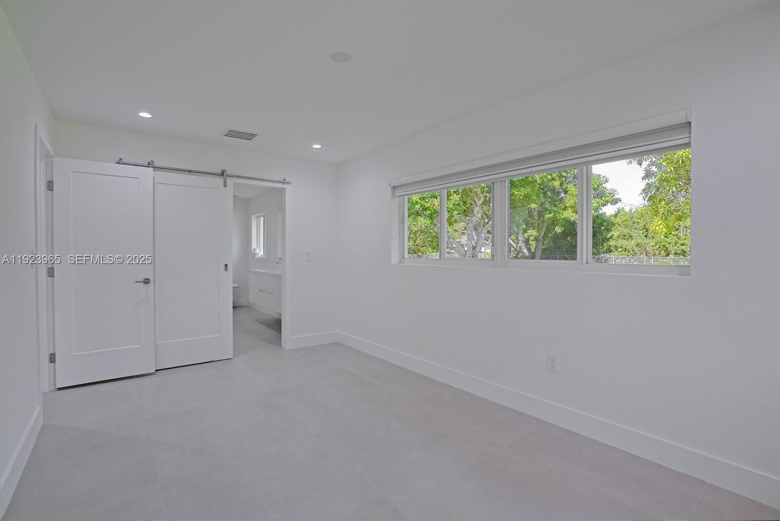 9301 Southwest 178th Street Palmetto Bay, FL 33157 - Photo 12 of 23 a view of an empty room with a window