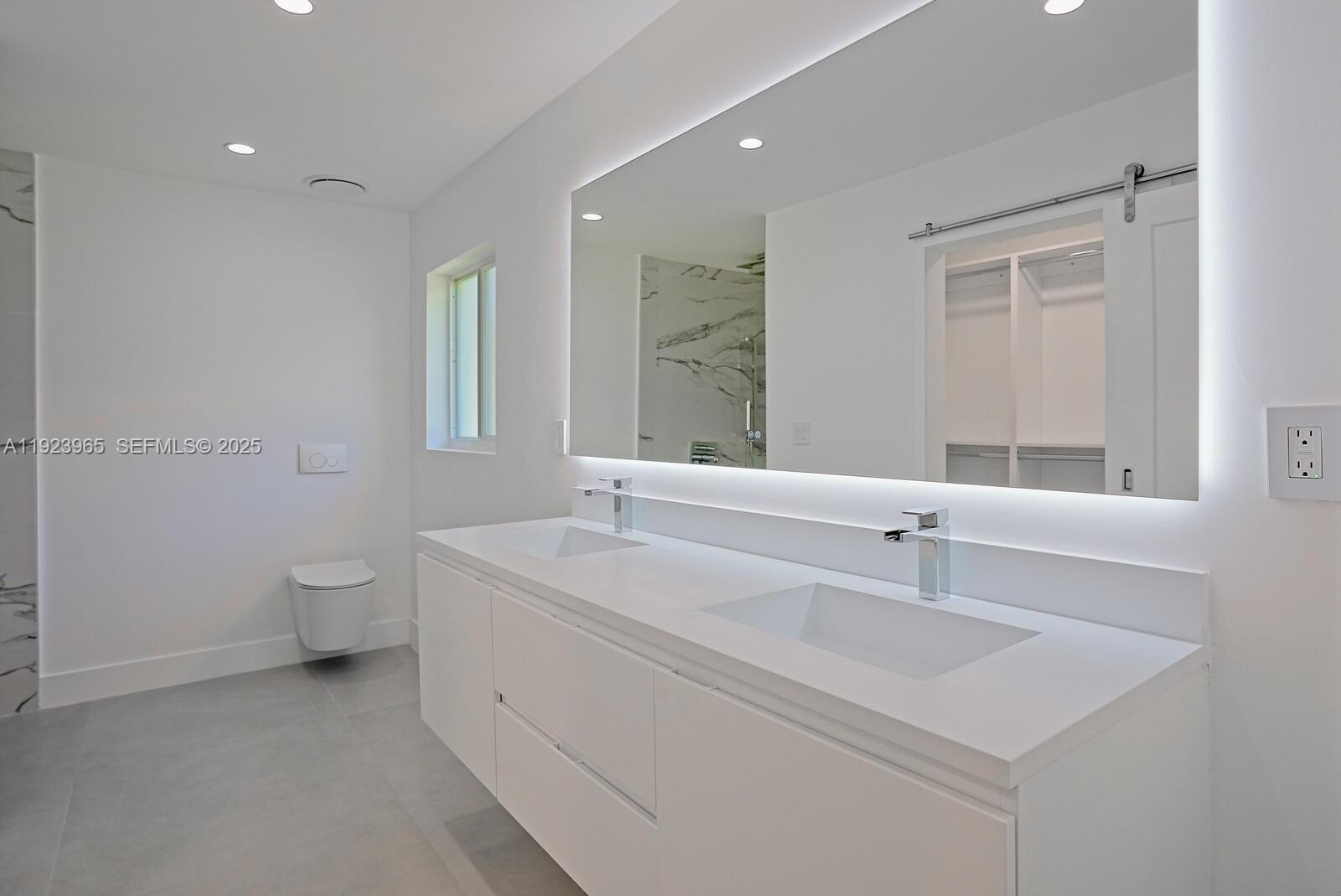 9301 Southwest 178th Street Palmetto Bay, FL 33157 - Photo 13 of 23 a bathroom with a sink a toilet and a mirror