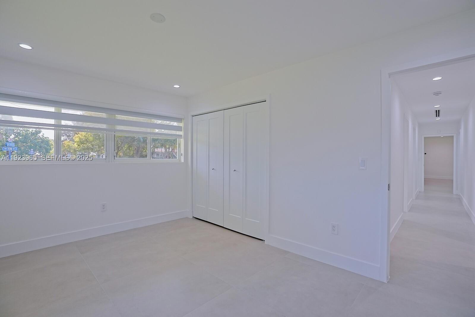 9301 Southwest 178th Street Palmetto Bay, FL 33157 - Photo 16 of 23 an empty room with windows