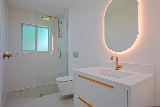 a bathroom with a sink a toilet and a mirror
