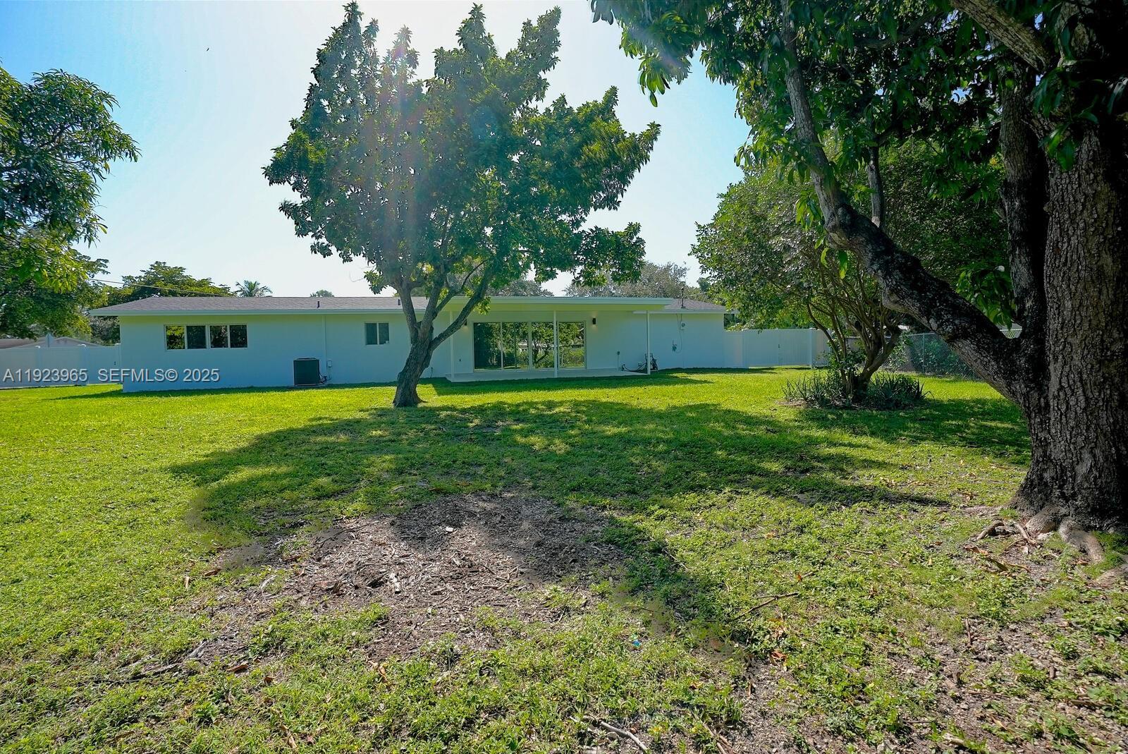9301 Southwest 178th Street Palmetto Bay, FL 33157 - Photo 23 of 23 a view of yard with swimming pool and green space