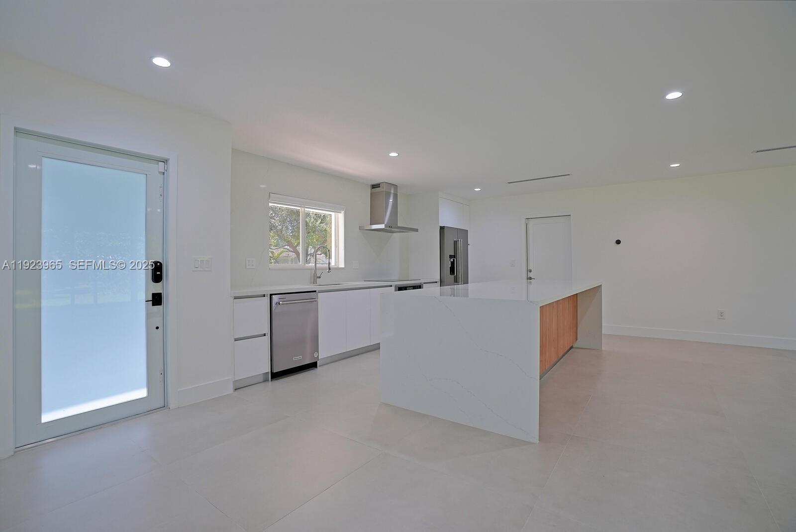 9301 Southwest 178th Street Palmetto Bay, FL 33157 - Photo 3 of 23 a view of a big room with kitchen and windows
