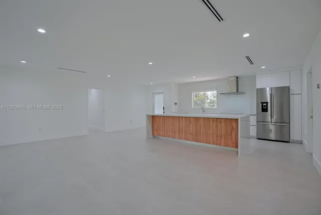 a view of kitchen with a refrigerator oven a counter space and wooden floor