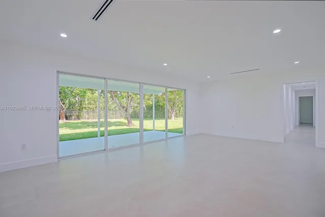 an empty room with large windows